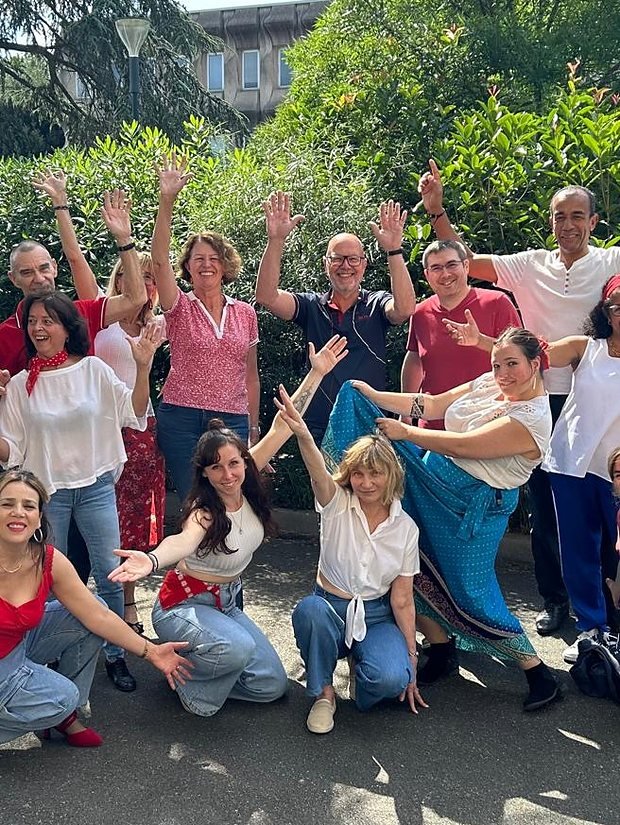 Les participants d'un stage collectif de Marine Valet, bras levés en extérieur